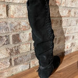 black suede boots with edging on both sides and black braided ankles